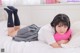 A woman laying on a bed with a pink pillow.