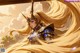 A woman with long blonde hair holding a sword.