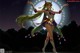 A woman in a sailor moon costume standing in front of a full moon.