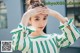 a woman wearing a green and white striped top